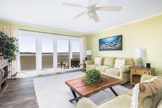 living room with ceiling fan, wood finished floors, and ornamental molding