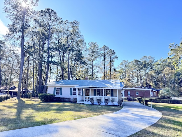 ranch-style home featuring a front yard, a porch, and a carport