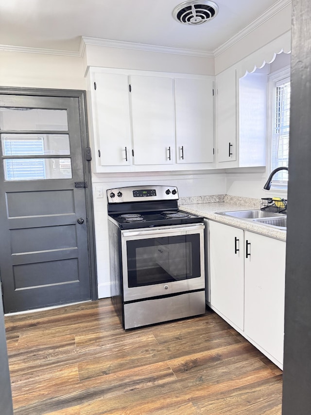 kitchen with ornamental molding, sink, dark hardwood / wood-style floors, white cabinetry, and stainless steel electric range