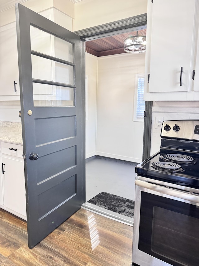 kitchen featuring dark hardwood / wood-style floors, white cabinetry, and stainless steel range with electric cooktop