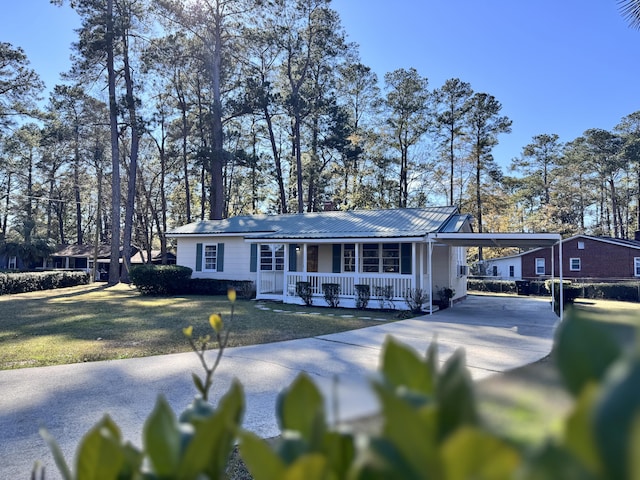 ranch-style house with a carport, covered porch, and a front yard