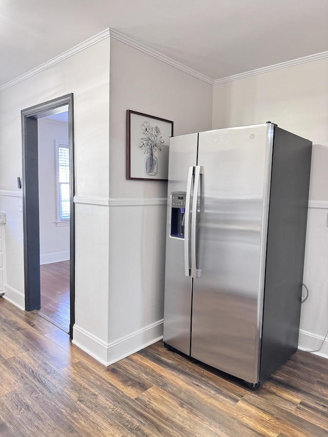 kitchen featuring stainless steel fridge, dark hardwood / wood-style flooring, and ornamental molding