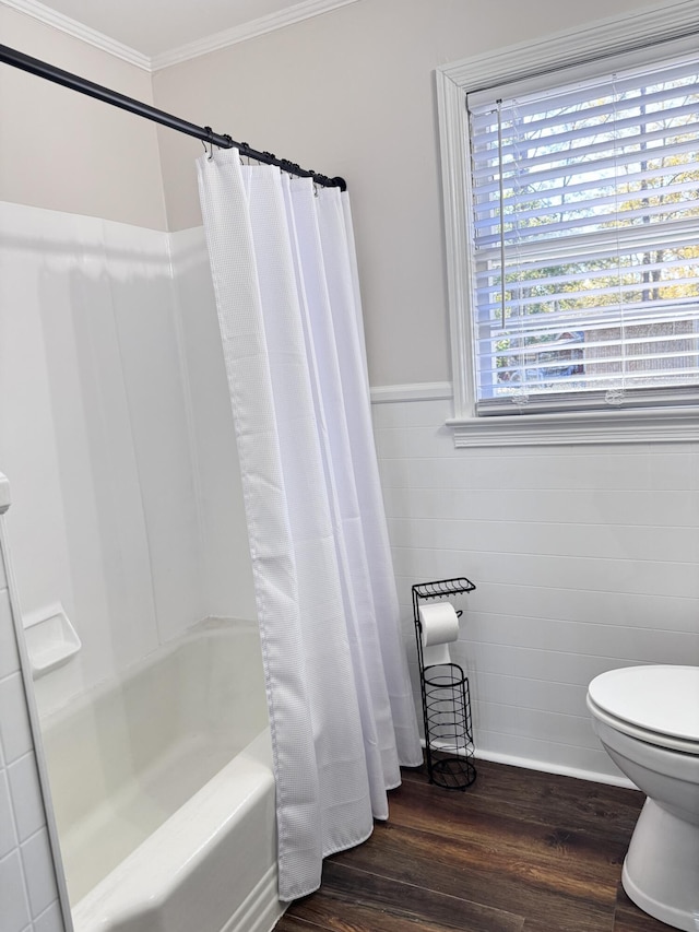 bathroom with wood-type flooring, toilet, ornamental molding, and shower / bath combo