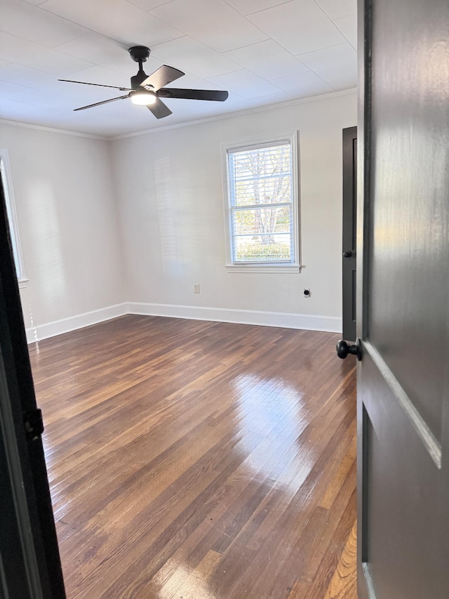 unfurnished room featuring ceiling fan, dark hardwood / wood-style flooring, and ornamental molding