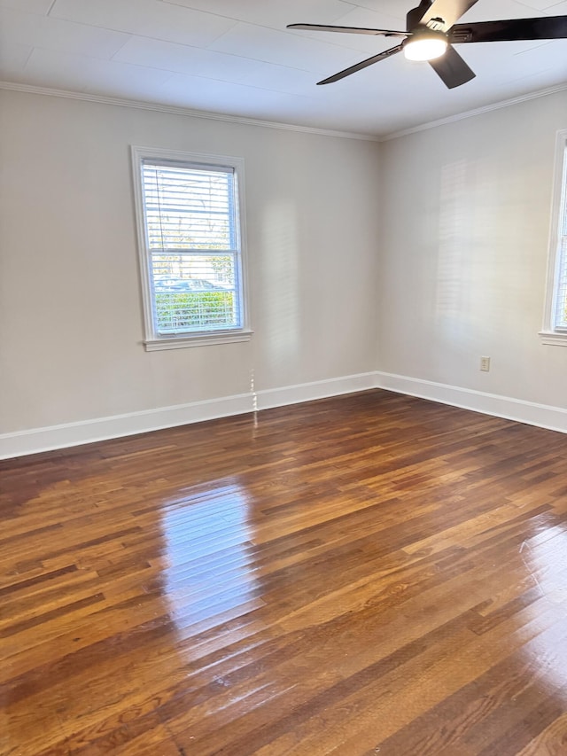 empty room featuring dark hardwood / wood-style floors, ceiling fan, and crown molding