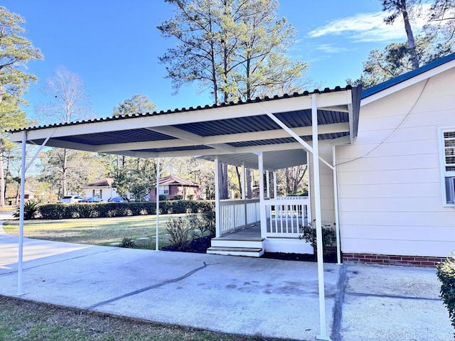 view of parking / parking lot with a yard and a carport