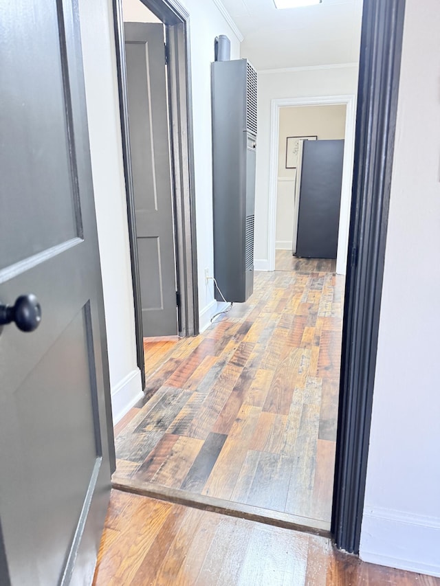 hall featuring hardwood / wood-style flooring and ornamental molding