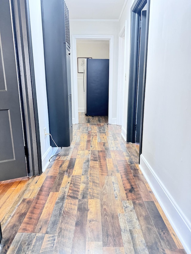 corridor featuring hardwood / wood-style floors and crown molding