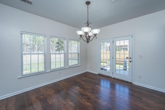 spare room with visible vents, dark wood-style flooring, and a wealth of natural light