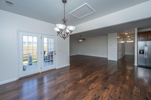 spare room with dark wood-style flooring, visible vents, and baseboards