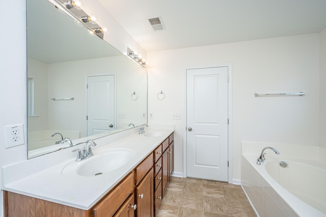 full bathroom featuring double vanity, visible vents, a sink, and a bath