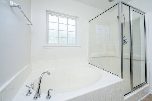 full bath featuring a shower stall and a bath