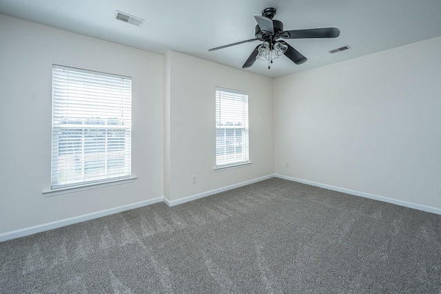 carpeted empty room with visible vents and baseboards