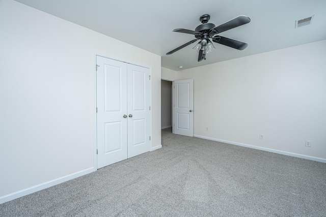 unfurnished bedroom featuring carpet, visible vents, and baseboards