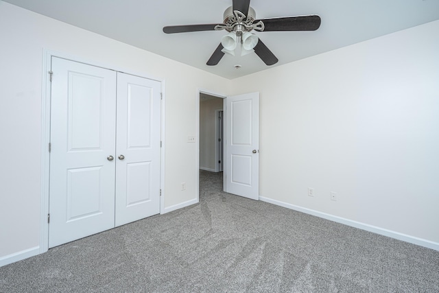 unfurnished bedroom with a ceiling fan, a closet, carpet flooring, and baseboards