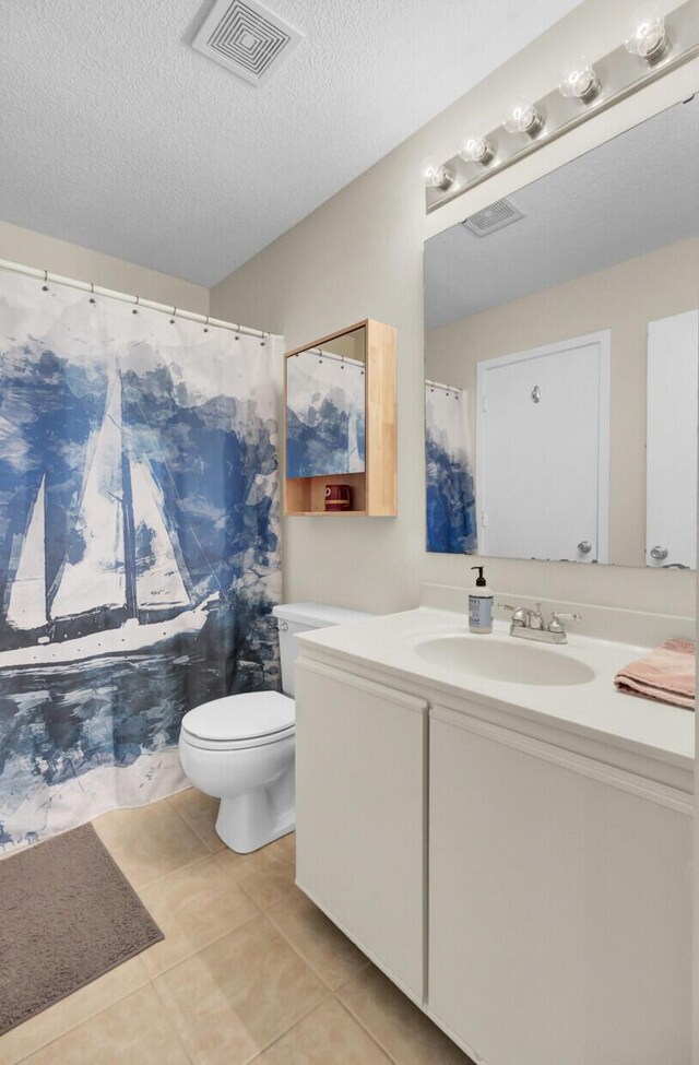 full bath with vanity, visible vents, a textured ceiling, tile patterned floors, and toilet