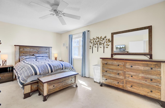 bedroom featuring light carpet and ceiling fan