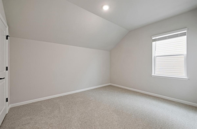 bonus room featuring lofted ceiling and carpet floors