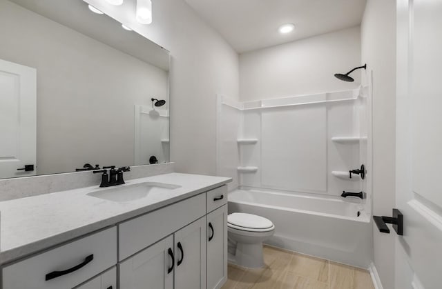 full bathroom featuring vanity, toilet, and  shower combination