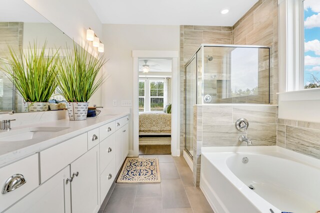 bathroom with tile patterned flooring, vanity, and separate shower and tub