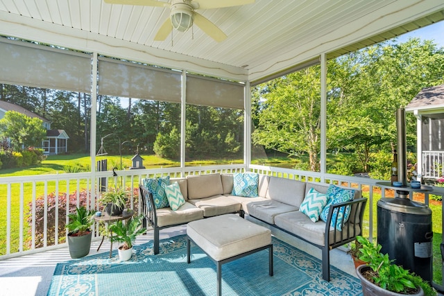 sunroom / solarium featuring ceiling fan and plenty of natural light