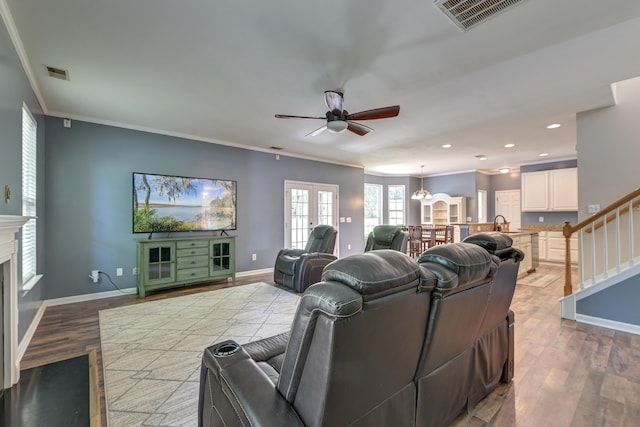 5105 Parrum Ct, Summerville, SC 29485 - living room featuring ceiling fan, crown molding, wood finished floors, a fireplace, and stairway