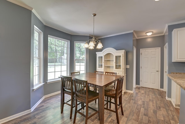 5105 Parrum Ct, Summerville, SC 29485 - dining area featuring a chandelier, healthy amount of natural light, dark wood-style floors, and ornamental molding