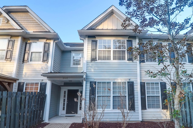 multi unit property with board and batten siding and fence