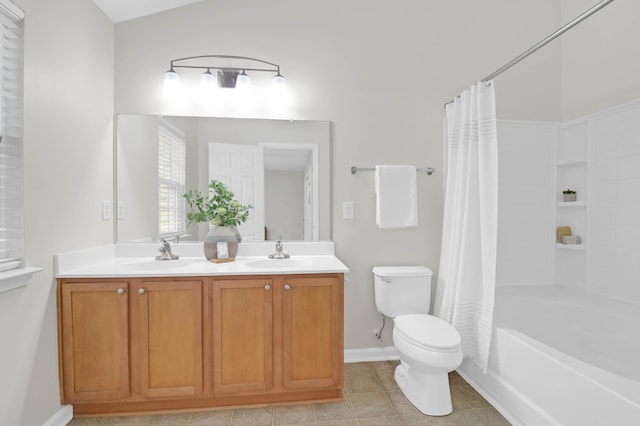 full bath featuring double vanity, tile patterned flooring, a sink, and toilet