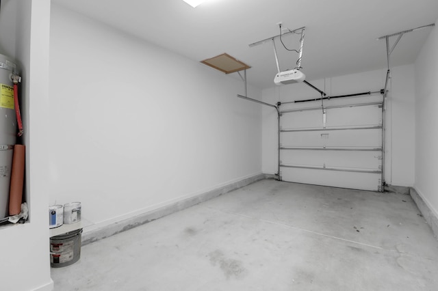 garage featuring a garage door opener and baseboards