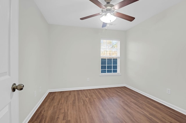 unfurnished room with ceiling fan, wood finished floors, and baseboards