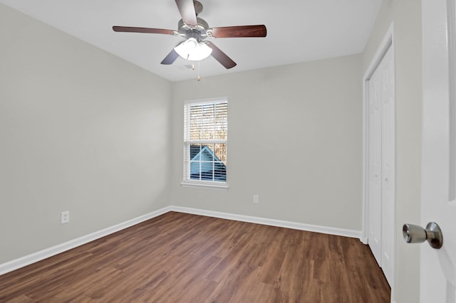 unfurnished bedroom featuring a ceiling fan, a closet, baseboards, and wood finished floors