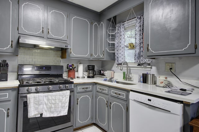 kitchen with stainless steel gas stove, gray cabinets, dishwasher, and sink