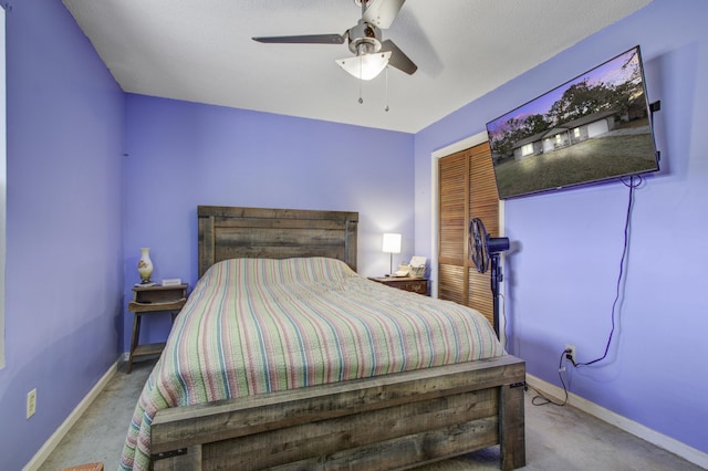 bedroom with ceiling fan and light carpet