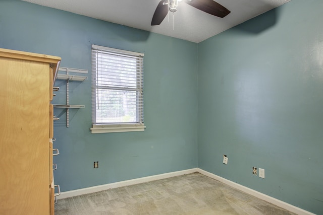 carpeted empty room with ceiling fan