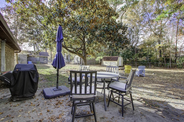 view of patio / terrace featuring a storage shed and grilling area