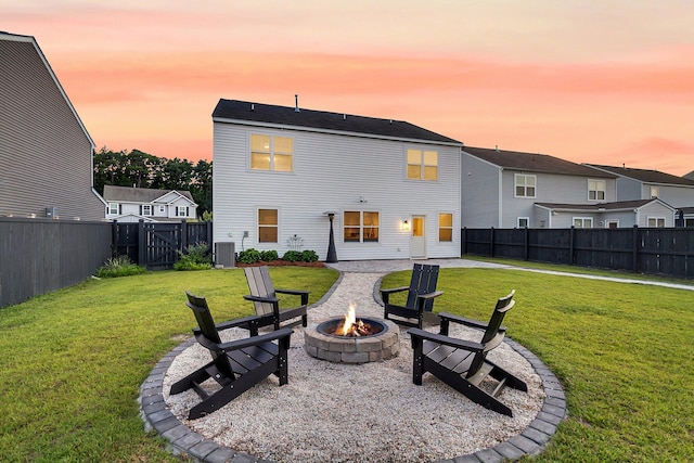 3018 Vincent Astor Dr, Johns Island, SC 29455 - back of house at dusk with a fire pit, a fenced backyard, and a residential view