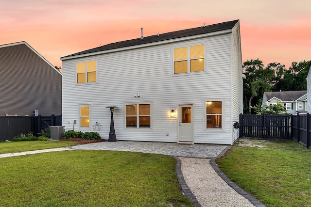 3018 Vincent Astor Dr, Johns Island, SC 29455 - back of house at dusk featuring a patio area and a fenced backyard
