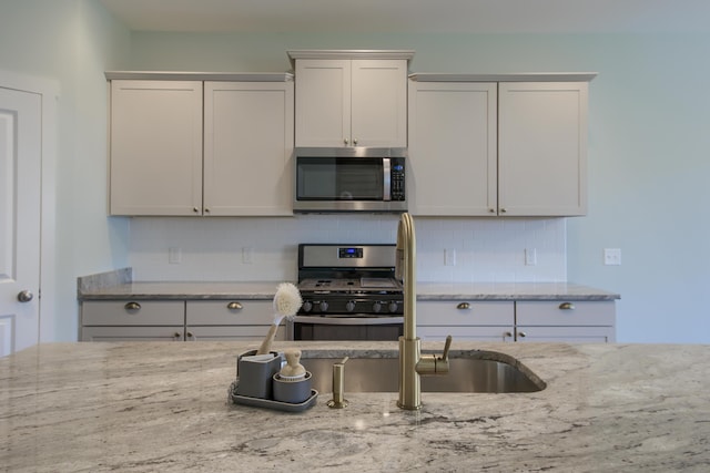 3018 Vincent Astor Dr, Johns Island, SC 29455 - kitchen with appliances with stainless steel finishes, light stone countertops, and backsplash