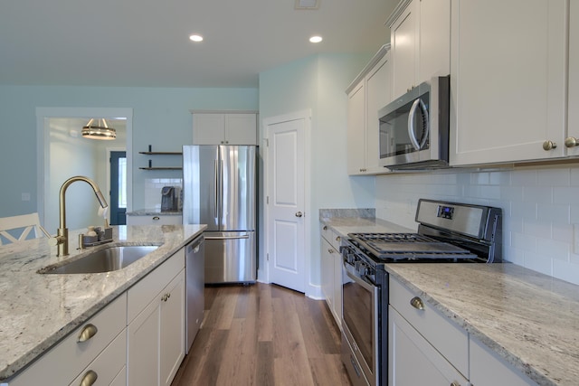 3018 Vincent Astor Dr, Johns Island, SC 29455 - kitchen featuring stainless steel appliances, white cabinets, dark wood finished floors, backsplash, and light stone countertops