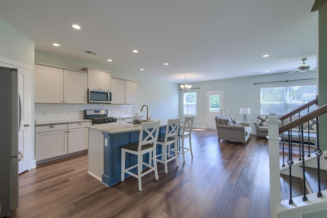 3018 Vincent Astor Dr, Johns Island, SC 29455 - kitchen featuring stainless steel appliances, tasteful backsplash, dark wood-style flooring, open floor plan, and recessed lighting