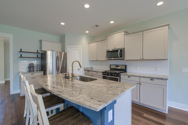 3018 Vincent Astor Dr, Johns Island, SC 29455 - kitchen with stainless steel appliances, backsplash, dark wood-style flooring, a breakfast bar, and recessed lighting