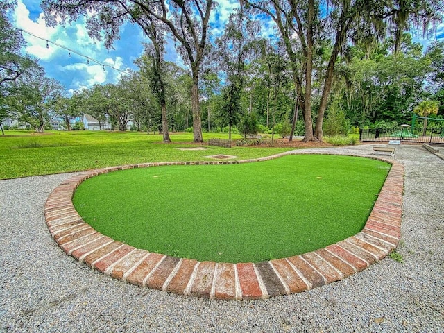 3018 Vincent Astor Dr, Johns Island, SC 29455 - view of home's community with a lawn, an area to practice putting, and view of wooded area