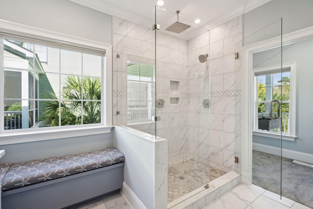 bathroom with crown molding and a shower with shower door