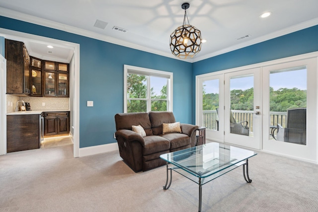 carpeted living room featuring ornamental molding