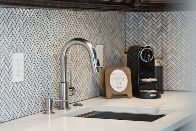 interior details with light stone countertops and sink