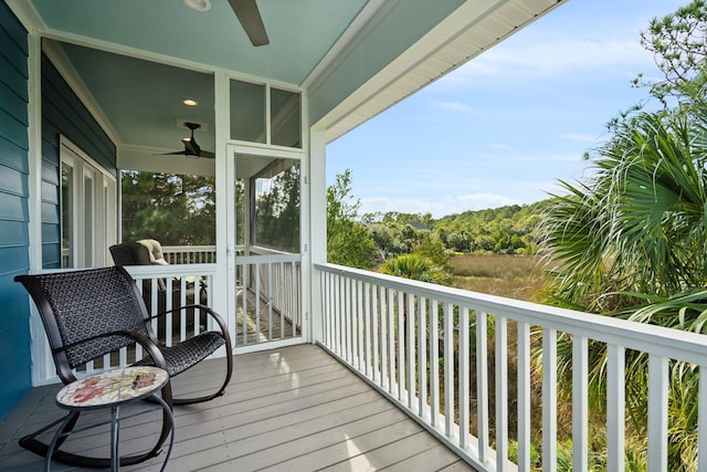 wooden deck featuring ceiling fan