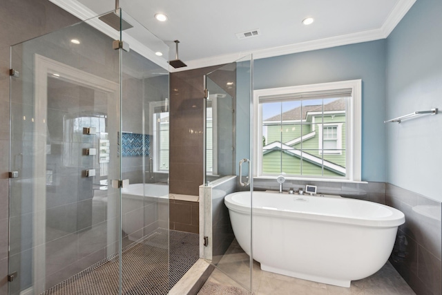 bathroom featuring shower with separate bathtub, tile patterned floors, tile walls, and ornamental molding