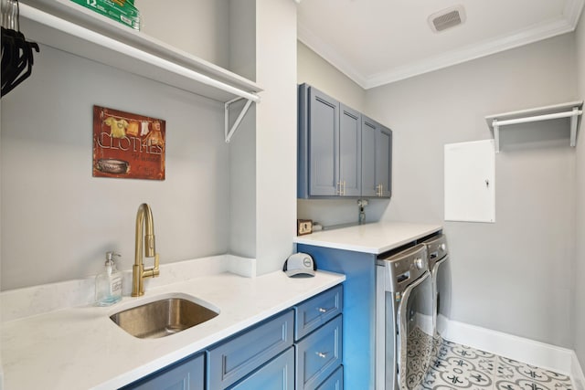 washroom featuring cabinets, ornamental molding, sink, light tile patterned floors, and washing machine and clothes dryer