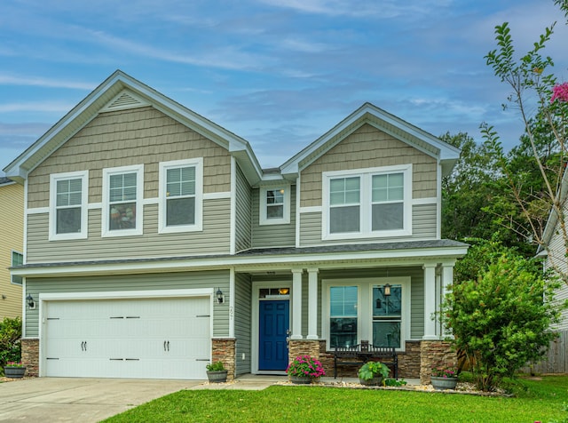 craftsman house with a garage, a front lawn, and covered porch